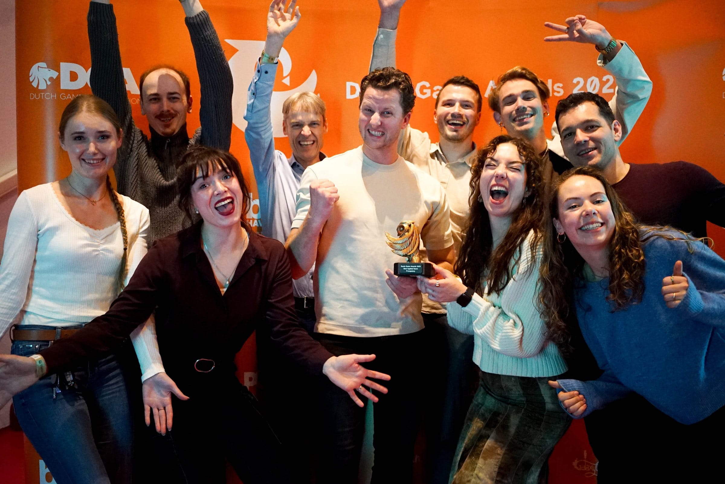 The Freequency team cheering with the Dutch Game Awards trophy